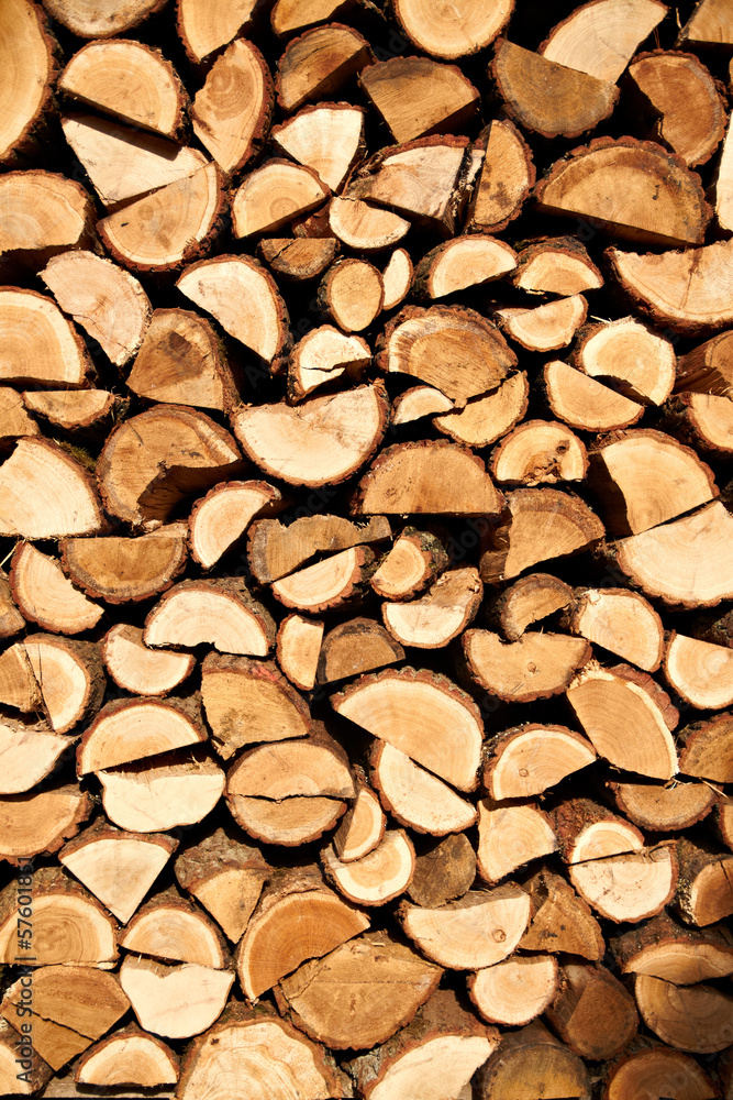 Background of dry chopped firewood logs stacked up on top of Background of dry chopped firewood logs stacked up on top of