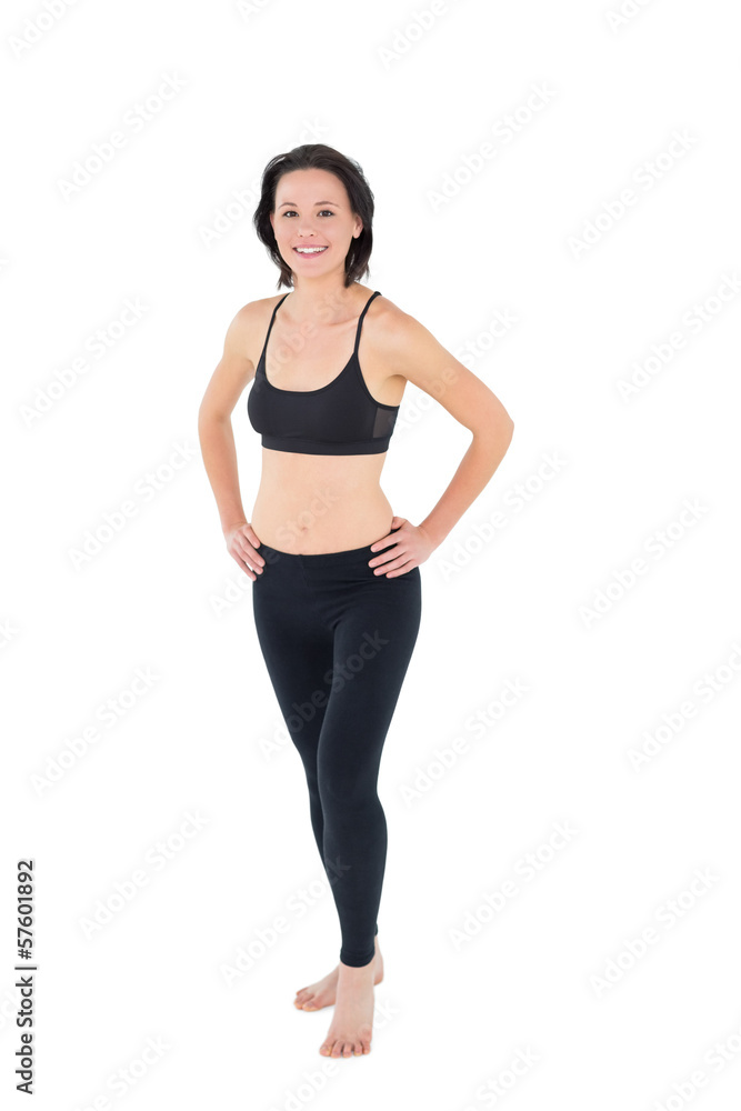 Full length of a sporty woman with hands on hips Full length of a sporty woman with hands on hips