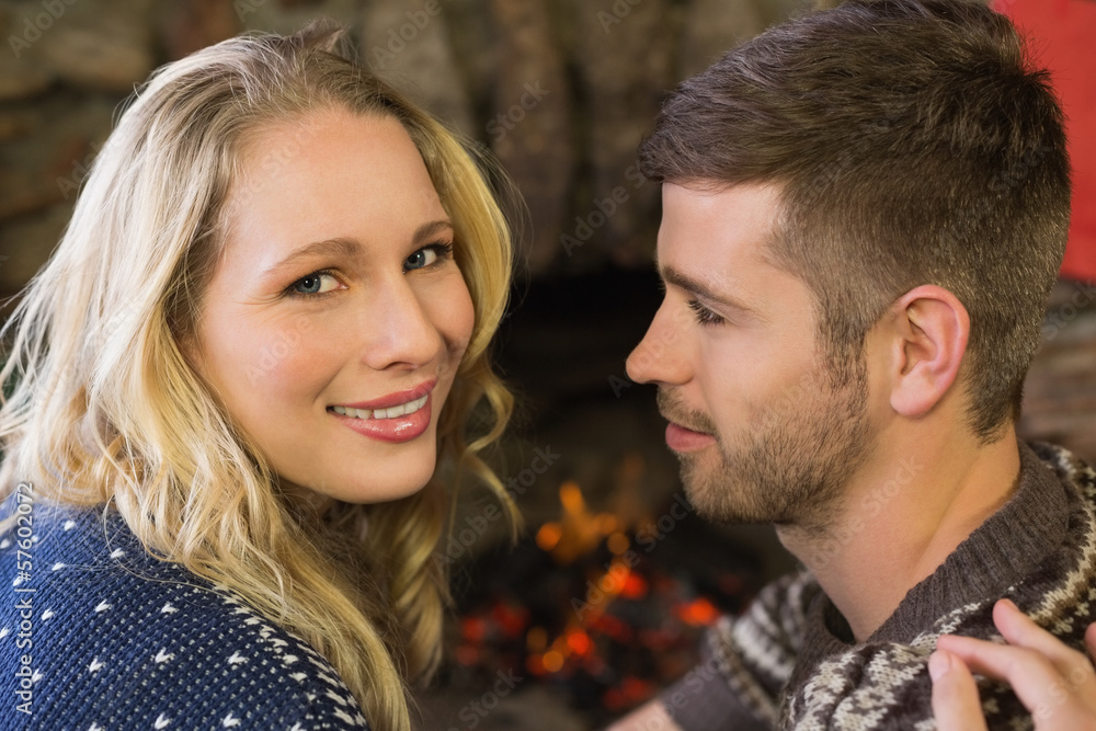 Close-up of a romantic couple in front of fireplace Close-up of a romantic couple in front of fireplace