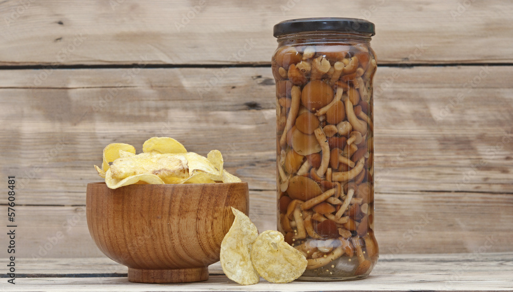 potato chips with mushrooms on wooden background potato chips with mushrooms on wooden background