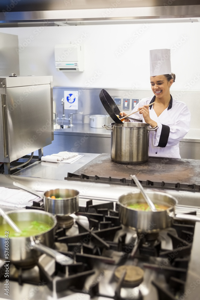 Young cheerful chef preparing meal Young cheerful chef preparing meal