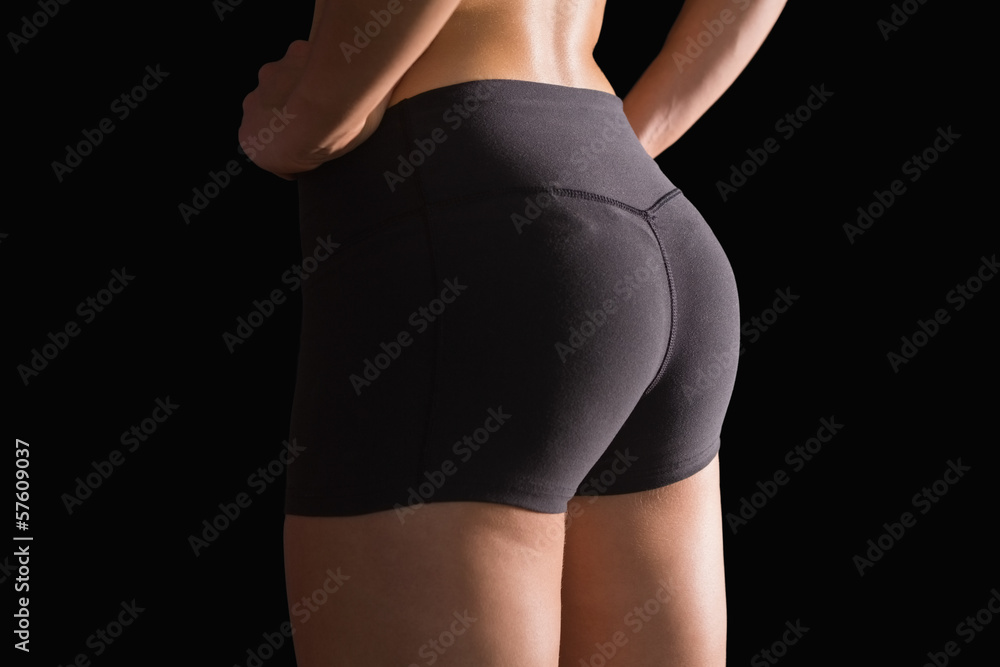 Fototapeta premium Mid section of sporty young woman wearing sportswear