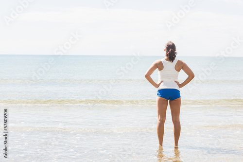Slender fit woman standing on the beach