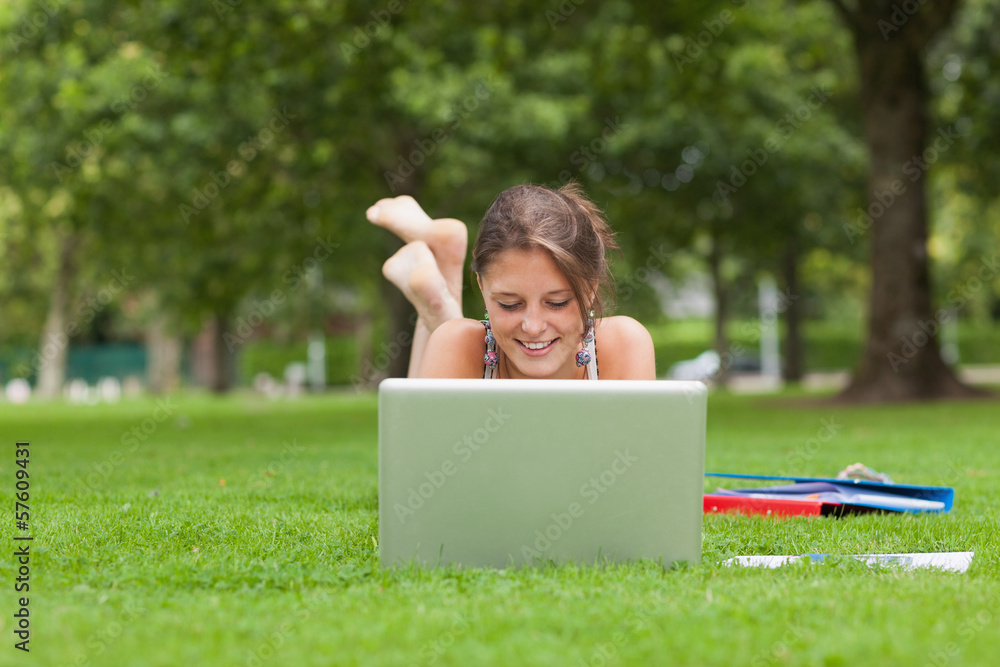 Female student with laptop and books at the park Female student with laptop and books at the park