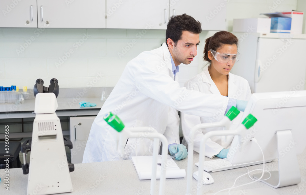 Serious researchers using a computer in the lab Serious researchers using a computer in the lab