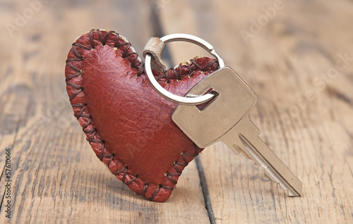 Fényképezés Key with leather trinket on wooden background