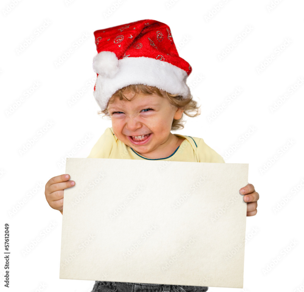 Kleiner Junge mit Weihnachtsmütze hält eine weiße Tafel Kleiner Junge mit Weihnachtsmütze hält eine weiße Tafel