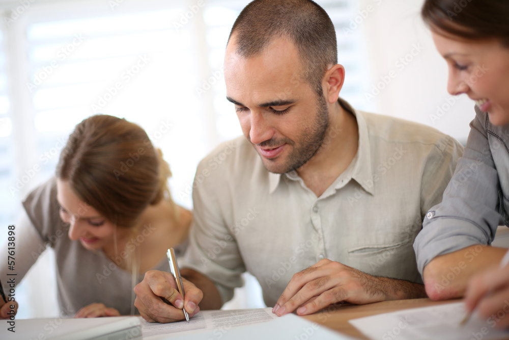 © goodluz - Young people filling admission form for business training
