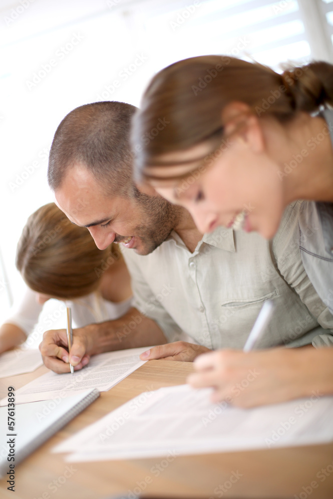 Young people filling admission form for business training