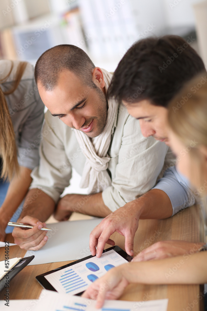 Business team working on marketing plan Business team working on marketing plan