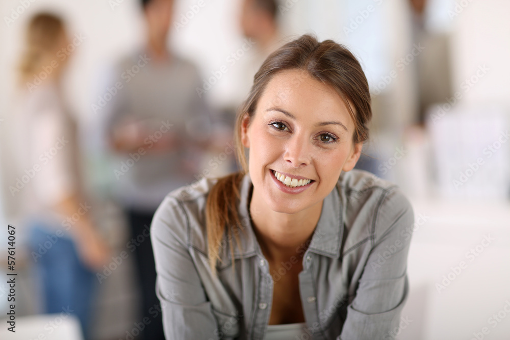 Portrait of business girl sitting on table in office Portrait of business girl sitting on table in office