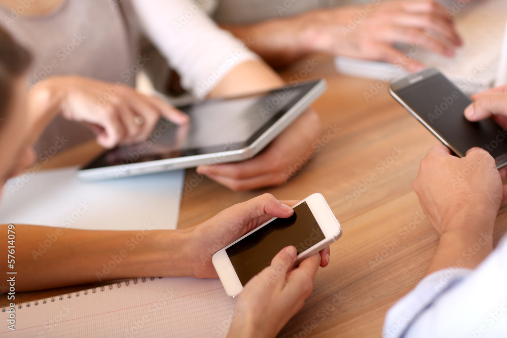 Fototapeta premium Group of business people using electronic devices at work