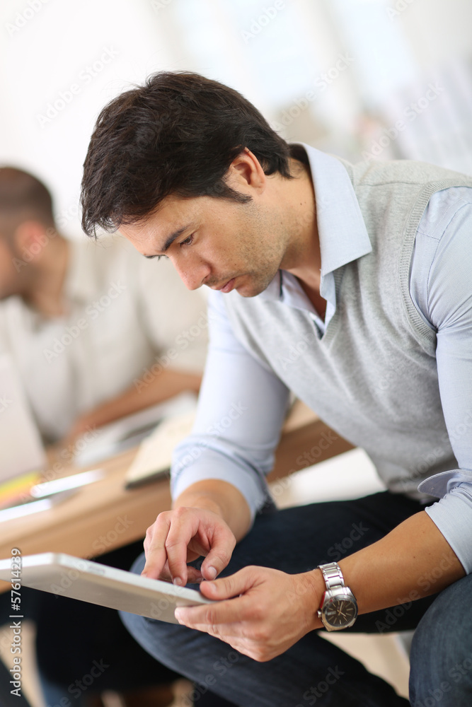 Businessman in office working on digital tablet Businessman in office working on digital tablet