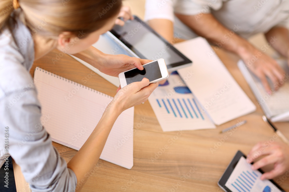Group of business people using electronic devices at work Group of business people using electronic devices at work