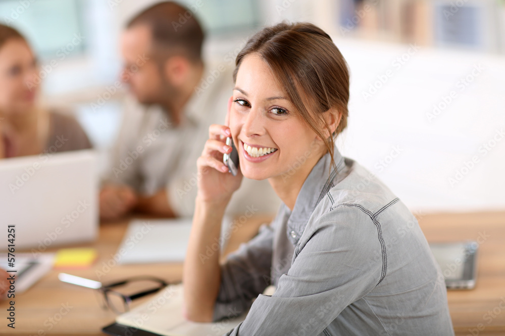 Girl in office talking on the phone Girl in office talking on the phone