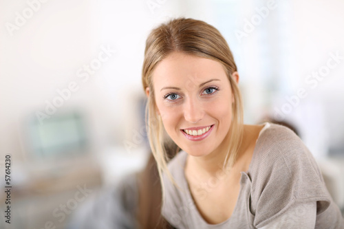 Portrait of pretty young woman in office
