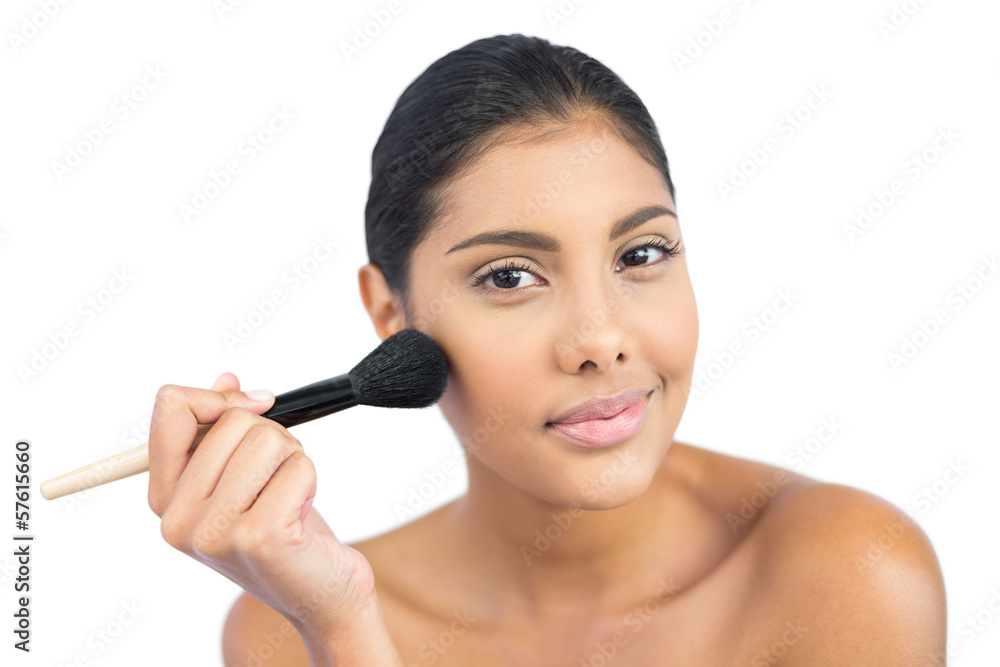 Pleased nude brunette using powder brush Pleased nude brunette using powder brush