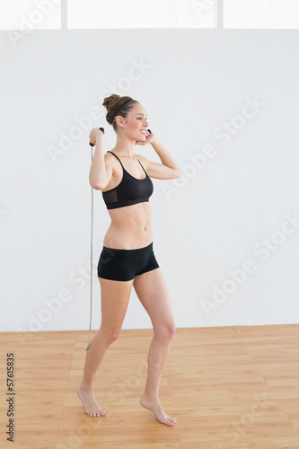 Side view of content sporty woman holding a skipping rope © lightwavemedia