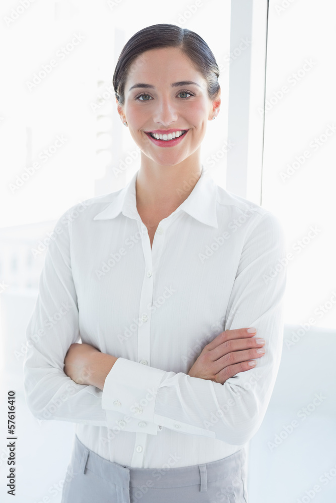 Young business woman standing with arms crossed Young business woman standing with arms crossed