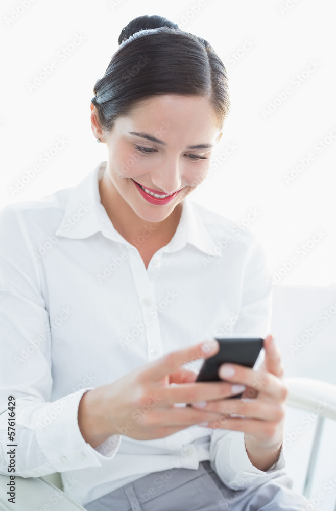Smiling business woman using mobile phone Smiling business woman using mobile phone
