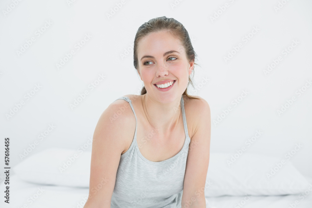 Happy woman looking away in bed Happy woman looking away in bed