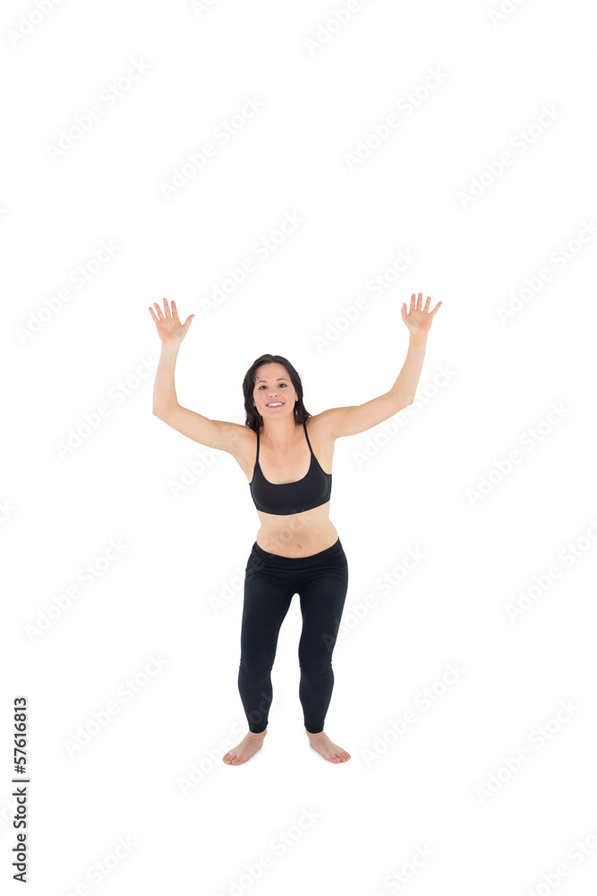 Sporty young woman about to jump over white background