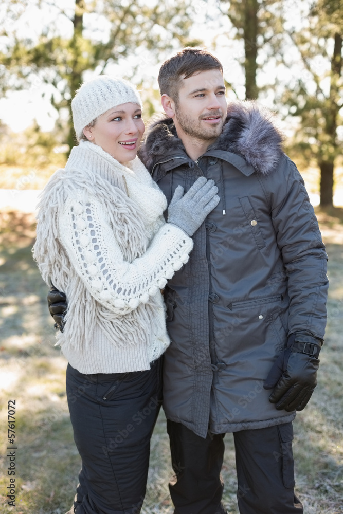 Fototapeta premium Loving young couple in winter clothing in the woods