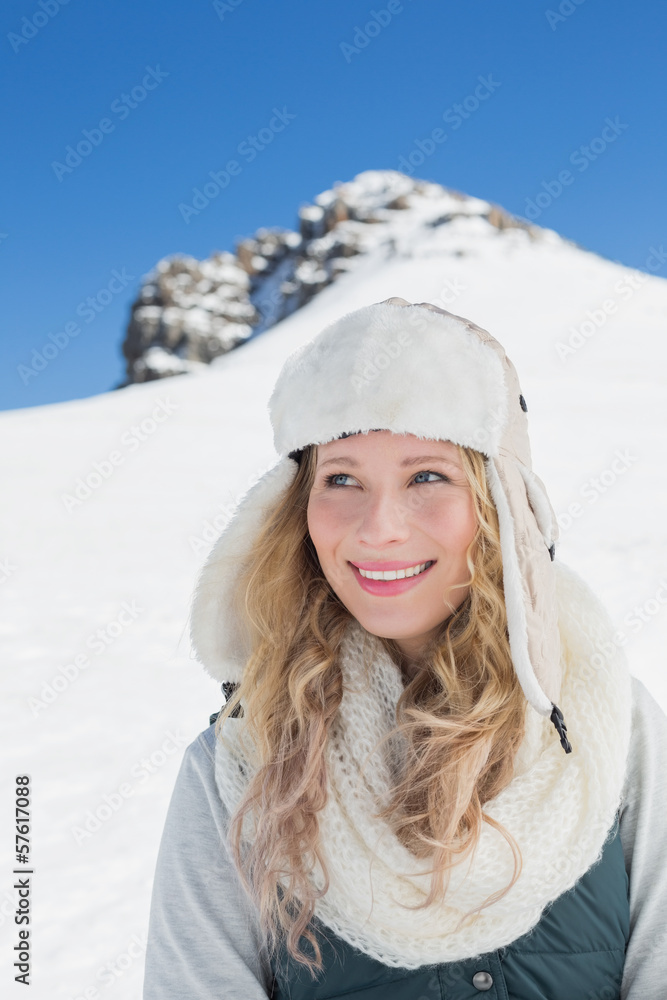 Smiling woman in front of snowed hill and clear blue sky Smiling woman in front of snowed hill and clear blue sky