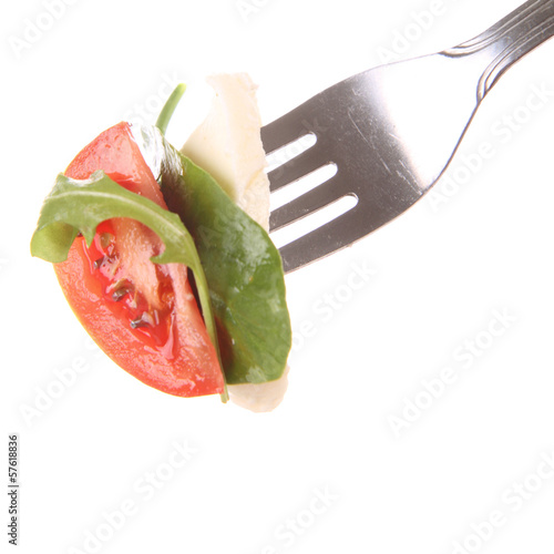 Tomato, spinach & rucola, mozzarella on fork on white