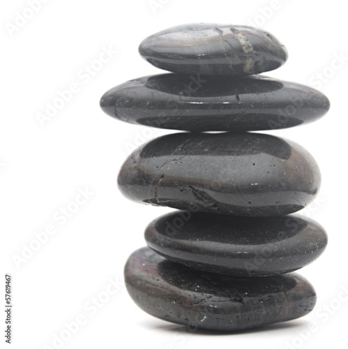 Black massage stones stacked  isolated on white