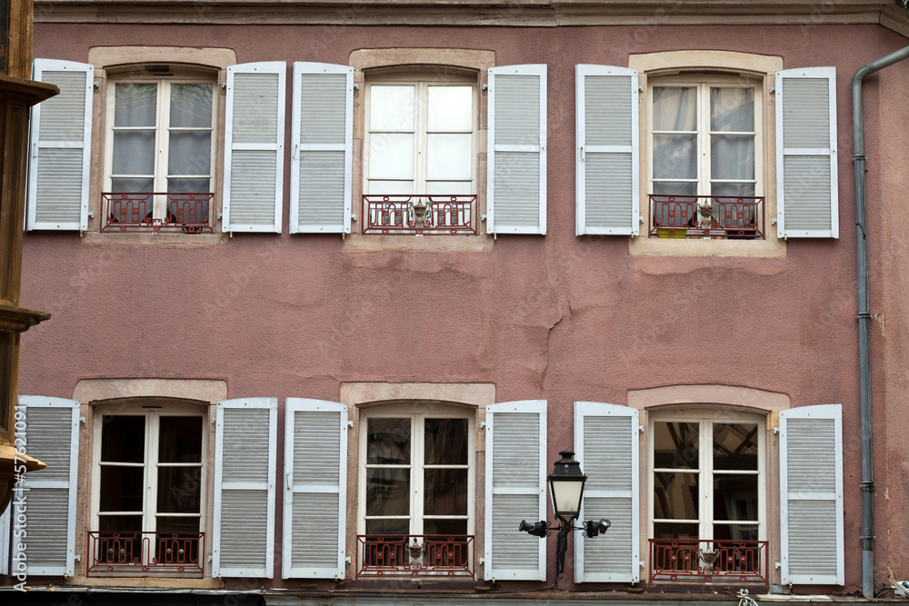the facade with white window shutters