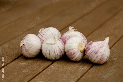 Few bulbs of garlic on wooden table
