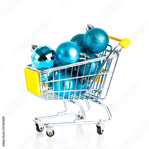 Shopping cart full of christmas balls isolated on white backgrou