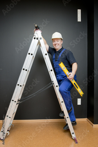 worker standing on a ladder © Artur Golbert