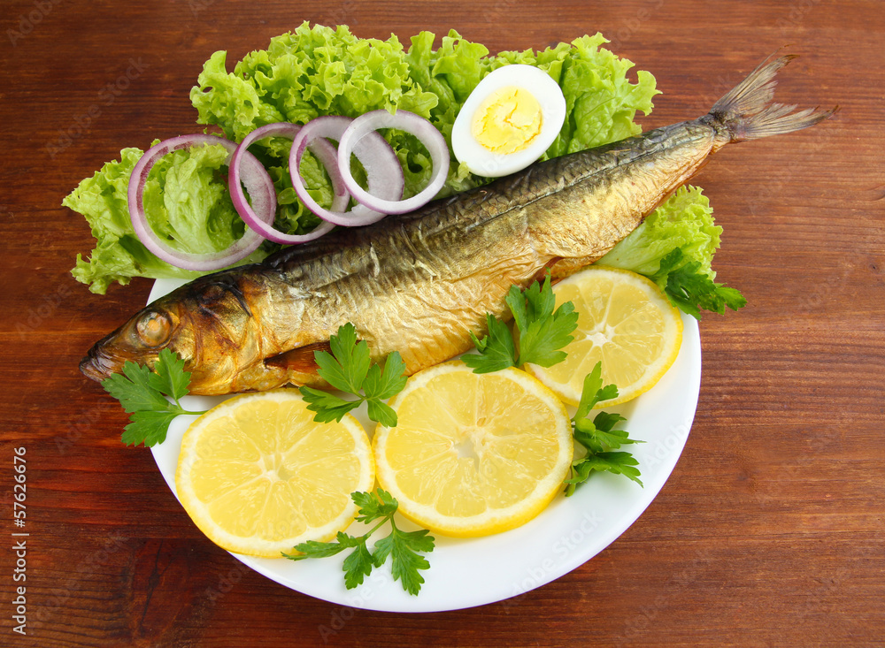 Smoked fish on plate on wooden table Smoked fish on plate on wooden table