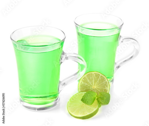 Two transparent cups of green tea with lime isolated on white