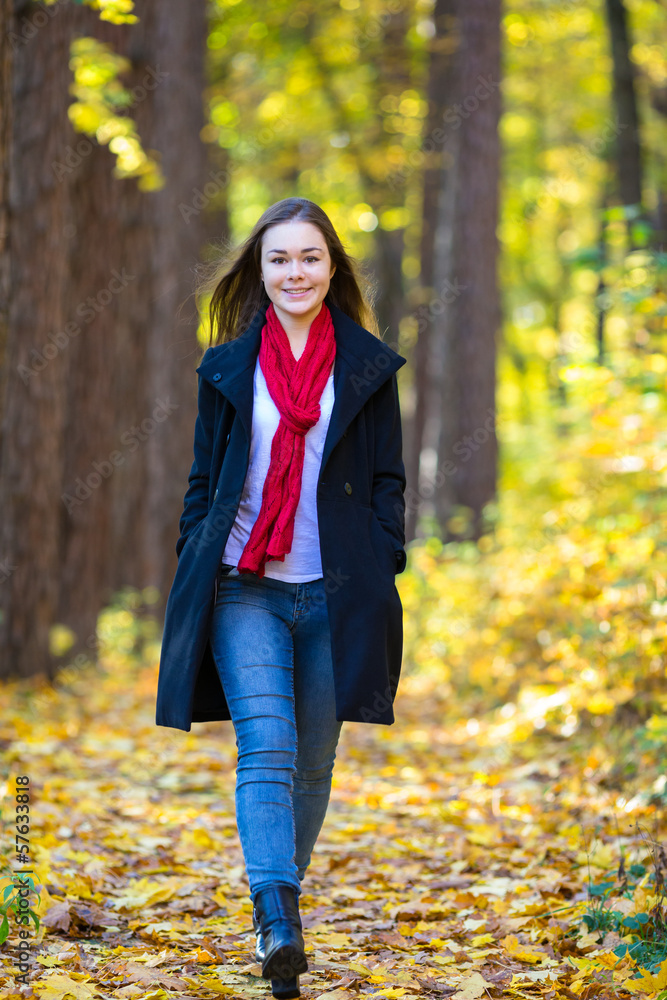 Teenage girl walking in city park Teenage girl walking in city park