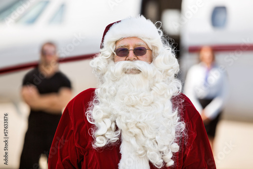 Santa Standing Against Private Jet
