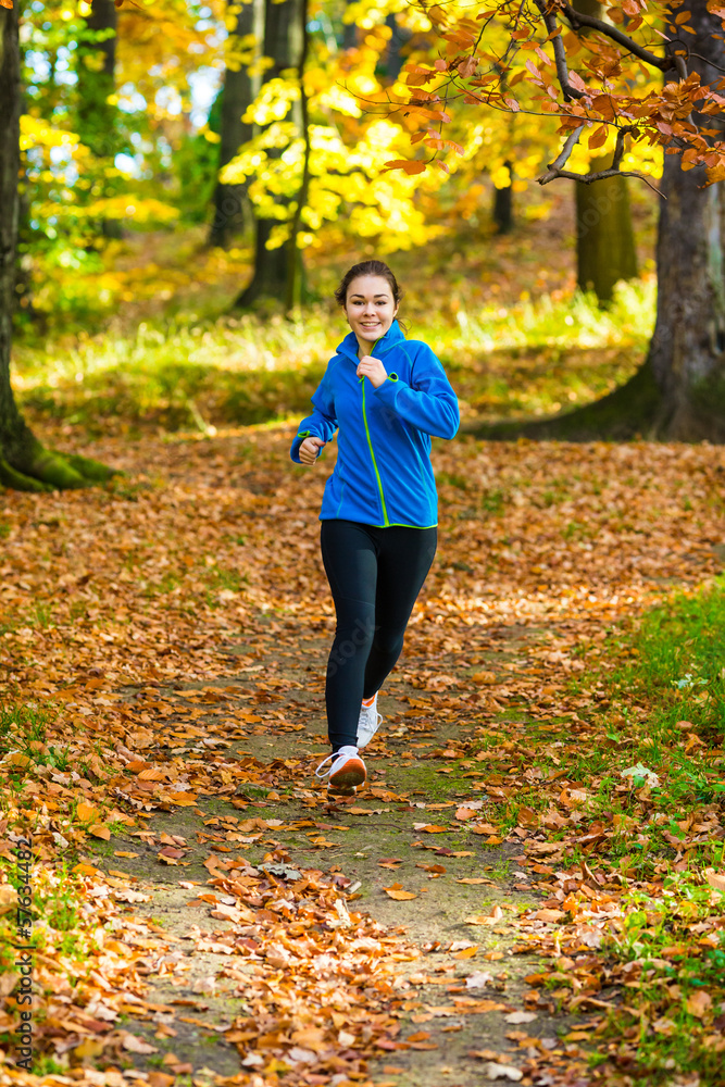 Young woman running in autumn park Young woman running in autumn park