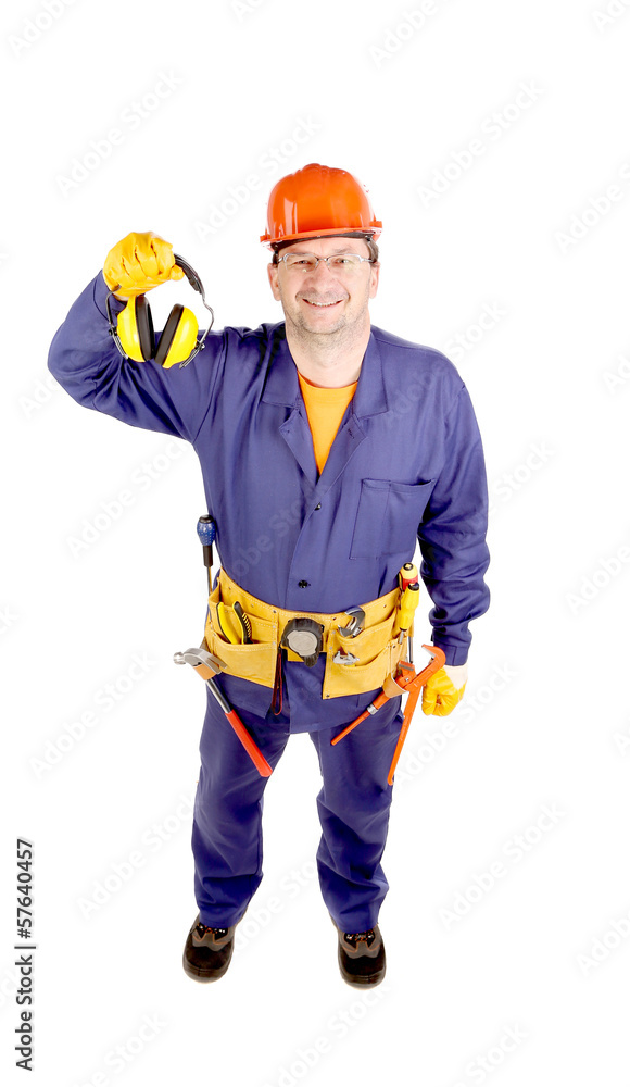 Worker in hard hat holding ear muffs Worker in hard hat holding ear muffs