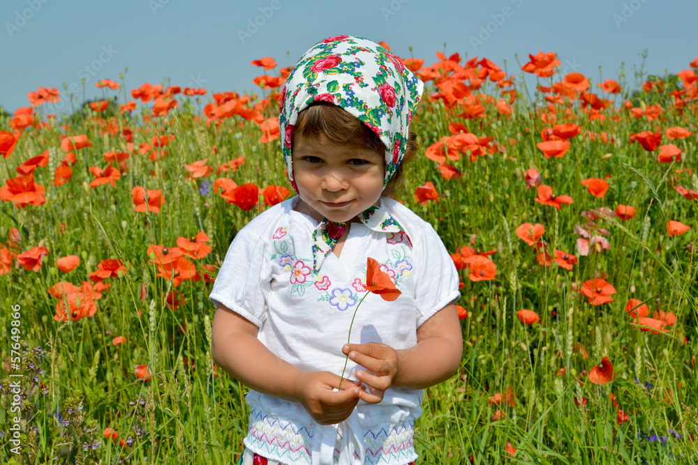 The little girl keeps red poppy in a poppy field The little girl keeps red poppy in a poppy field