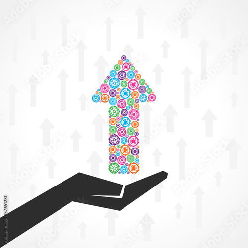 Hand holds arrow of gears for business concept