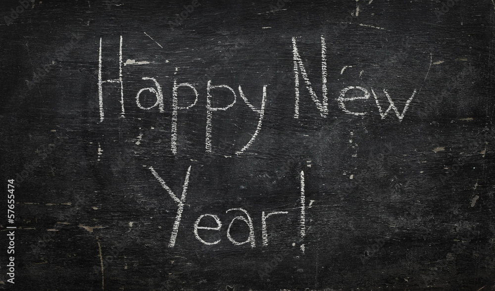 Chalk on black board: Happy new year Chalk on black board: Happy new year