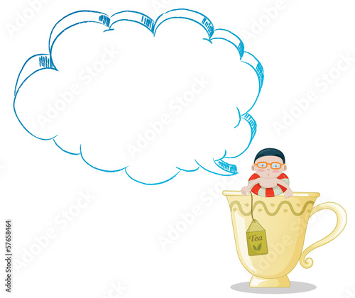 A big tea cup with a young boy