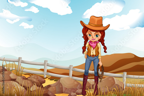 A pretty cowgirl near the rocks