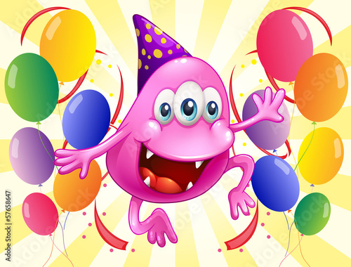A pink beanie monster in the middle of the balloons