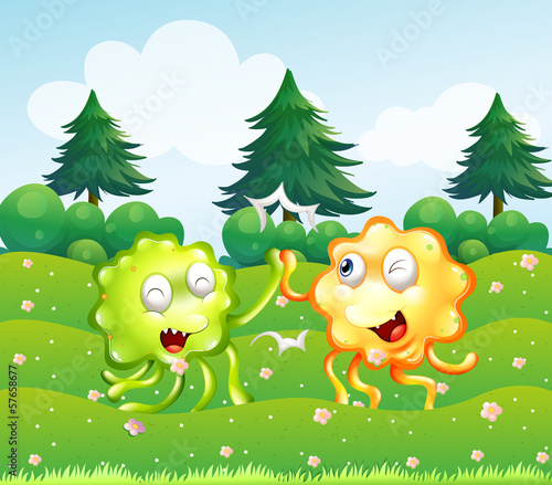 A green and an orange monster near the pine trees