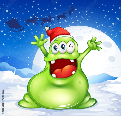 A fat green monster wearing a red Santa hat
