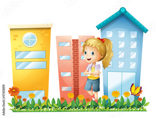 A girl in front of the buildings with a garden