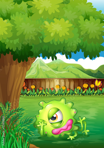 A yard with a monster resting under the tree